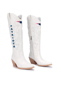 A pair of white western cowboy boots featuring the New England Patriots logo and 'PATRIOTS' text on the shaft, set against a plain white background.