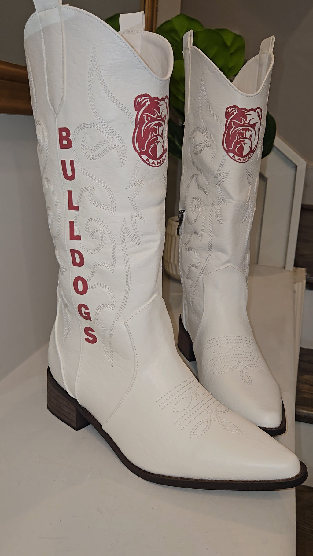 HBCU Homecoming gameday  cowboy boots with Maroon Alabama A and M Bulldogs features. the word 'BULLDOGS' on the shaft, displayed on a white surface